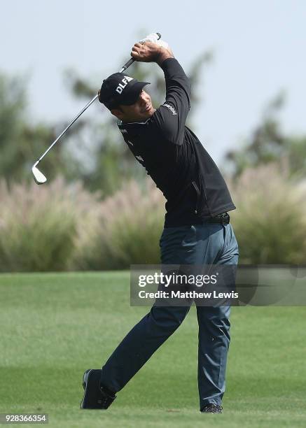 Shubhankar Sharma of India plays a shot form the 18th fairway during a practice round ahead of the Hero Indian Open at Dlf Golf and Country Club on...