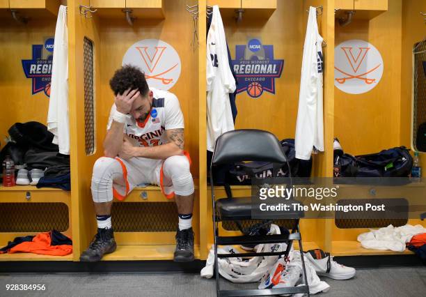 Virginia guard London Perrantes sits in the locker room after Syracuse defeats Virginia 68 -62 to win the Midwest regional final in the Men's NCAA...