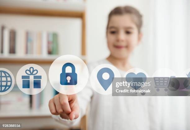 niña tocando el botón de seguridad en la pantalla digital - realista fotografías e imágenes de stock