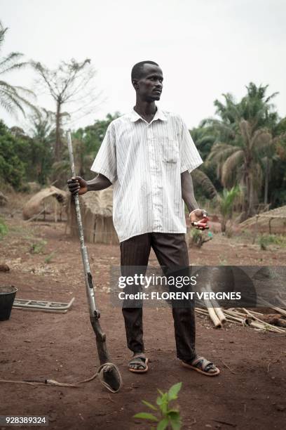 Brice, a man who was tortured by the the Lord Resistance Army while hunting in the bush around Mboki poses, in Obo, on February 17, 2018. Since the...