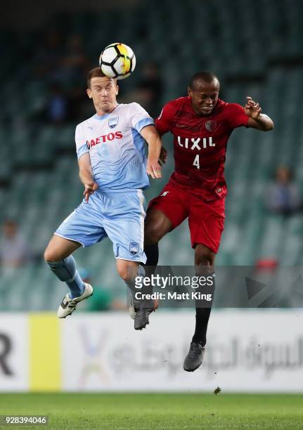 Brandon O'Neill of Sydney FC competes for the ball against Lo Silva of Kashima Antlers during the AFC Asian Champions League match between Sydney FC...