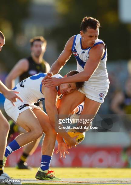 Ben Jacobs of the Kangaroos and Kayne Turner of the Kangaroos runs with the ball into each other during the AFL JLT Community Series match between...