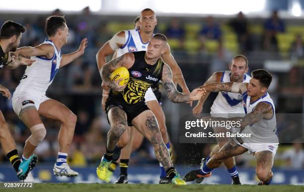 Dustin Martin of the Tigers runs with the ball during the AFL JLT Community Series match between the Richmond Tigers and the North Melbourne...