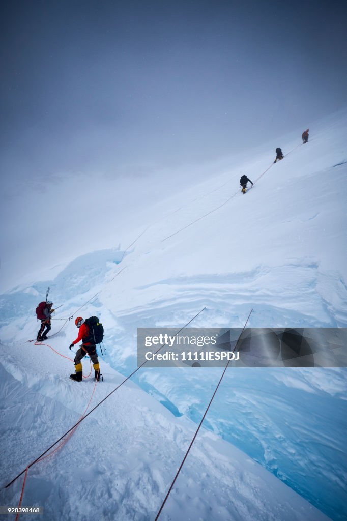 Mountaineers climb the headwall along the fixed ropes on Denali