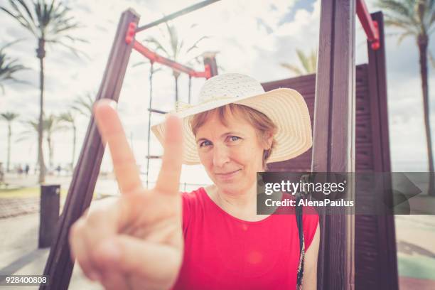 senior woman with sun hat - playa de las americas stock pictures, royalty-free photos & images