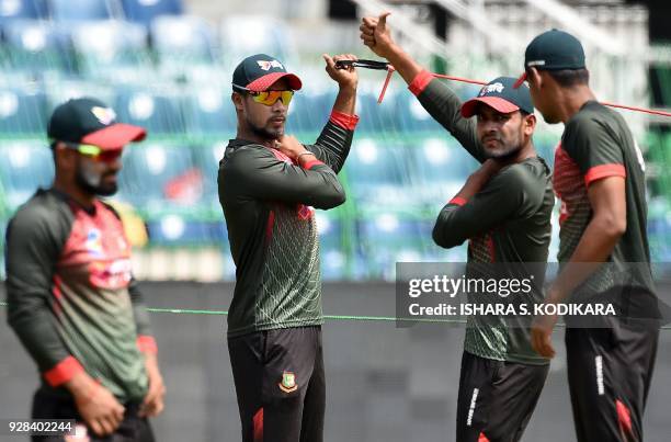 Bangladesh cricketer Sabbir Rahman and teammates stretches during a practice session at R. Premadasa International Cricket Stadium in Colombo on...