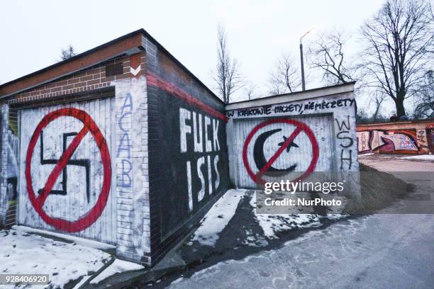 Politiical and anti-muslims graffiti seen on garages near Krakow's main train station area. On Monday, March 5 in Krakow, Poland.