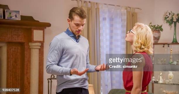 woman talking to man - thick rimmed spectacles stock pictures, royalty-free photos & images
