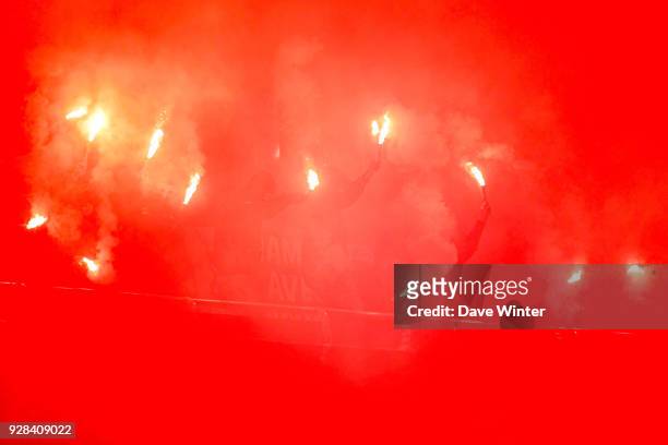 Fans light flares during the UEFA Champions League Round of 16 Second Leg match between Paris Saint Germain and Real Madrid at Parc des Princes on...