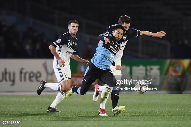 Yu Kobayashi of Kawasaki Frontale competes for the ball against James Donachie of Melbourne Victory during the AFC Champions League Group F match...