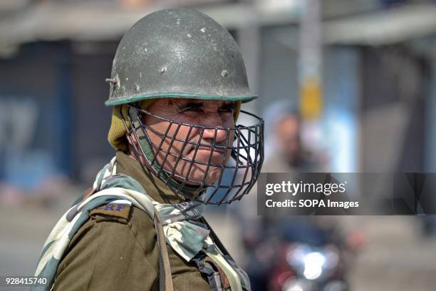 An Indian paramilitary trooper stands alert during restrictions in Srinagar, Indian administered Kashmir. Authorities imposed restrictions in many...