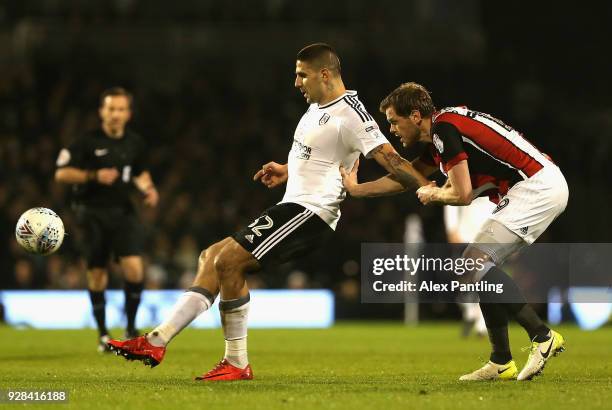 Aleksandar Mitrovic of Fulham holds off Richard Stearman of Sheffield United during the Sky Bet Championship match between Fulham and Sheffield...