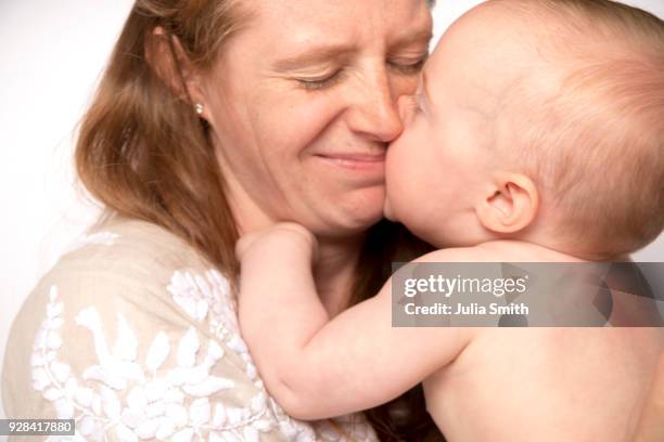 caucasian mother, 31, and caucasian baby, 10 months, on white seamless - julia smith stock pictures, royalty-free photos & images