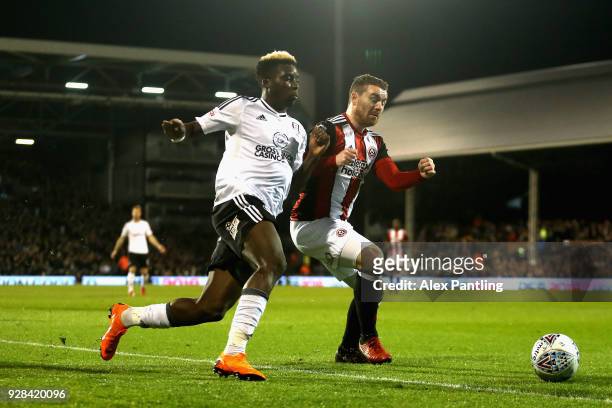 Sheyi Ojo of Fulham and Jack O'Connell of Sheffield United in action during the Sky Bet Championship match between Fulham and Sheffield United at...