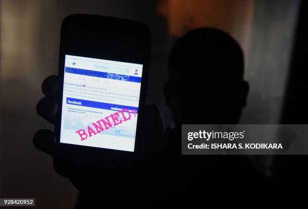 Sri Lankan man mobile phone user shows an image on Twitter showing that the Facebook site had been blocked in Colombo on March 7, 2018....