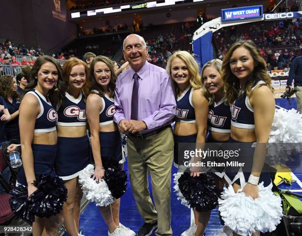 Sportscaster Dick Vitale poses with Gonzaga Bulldogs cheerleaders before the championship game of the West Coast Conference basketball tournament...