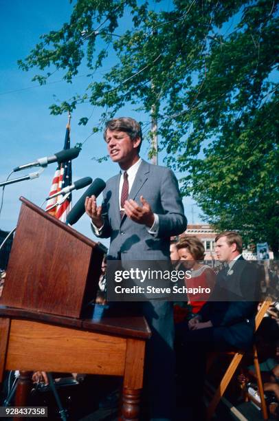 Senator Robert F Kennedy stands at a podium as he delivers a speech during his presidential campaign, Indiana, 1968. , Indiana, 1968. Among those...