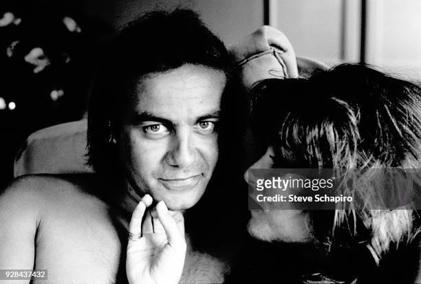 Portrait of shirtless British musician and lyricist Bernie Taupin and his wife, Toni Lynn Russo, Los Angeles, California, April 1980.