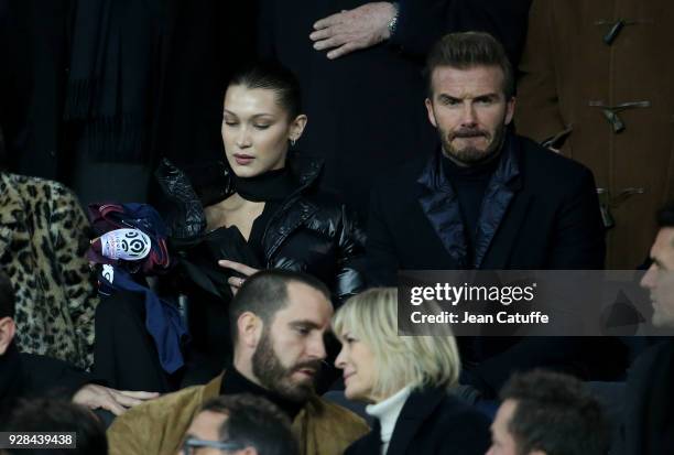 Bella Hadid, David Beckham, below Robin Wright and Clement Giraudet attend the UEFA Champions League Round of 16 Second Leg match between Paris...