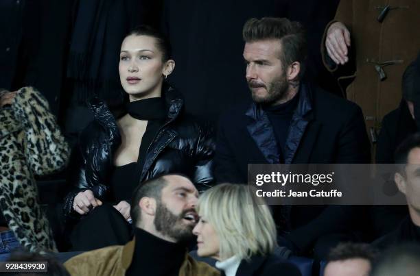 Bella Hadid, David Beckham, below Robin Wright and Clement Giraudet attend the UEFA Champions League Round of 16 Second Leg match between Paris...