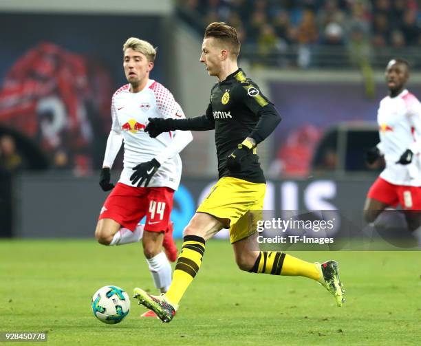 Kevin Kampl of Leipzig and Marco Reus of Dortmund battle for the ball during the Bundesliga match between RB Leipzig and Borussia Dortmund at Red...