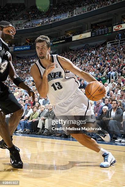 Mehmet Okur of the Utah Jazz drives the ball against Antonio McDyess of the San Antonio Spurs at EnergySolutions Arena on November 5, 2009 in Salt...