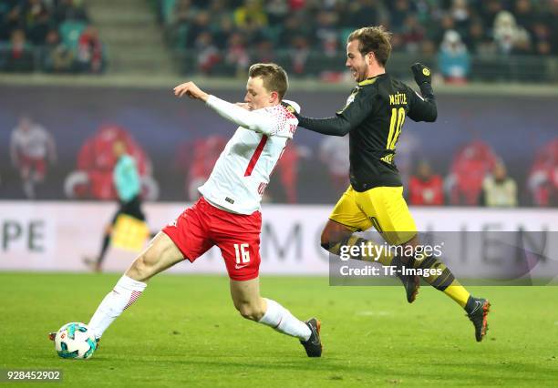 Lukas Klostermann of Leipzig and Mario Goetze of Dortmund battle for the ball during the Bundesliga match between RB Leipzig and Borussia Dortmund at...