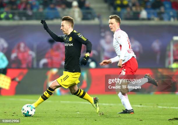 Marco Reus of Dortmund and Lukas Klostermann of Leipzig battle for the ball during the Bundesliga match between RB Leipzig and Borussia Dortmund at...