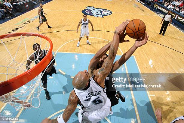 Carlos Boozer of the Utah Jazz blocks the shoot against Tim Duncan of the San Antonio Spurs at EnergySolutions Arena on November 5, 2009 in Salt Lake...