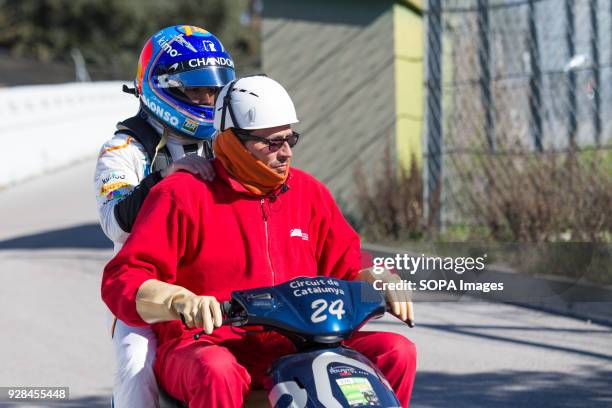 Fernando Alonso of Team McLaren-Honda, McLaren MCL33, go back to the box on a motorbike after his car's motor broke during F1 Winter Test Days.