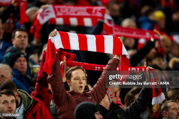 Fans of Liverpool hold up scarves during the UEFA Champions League Round of 16 Second Leg match between Liverpool and FC Porto at Anfield on March 6,...