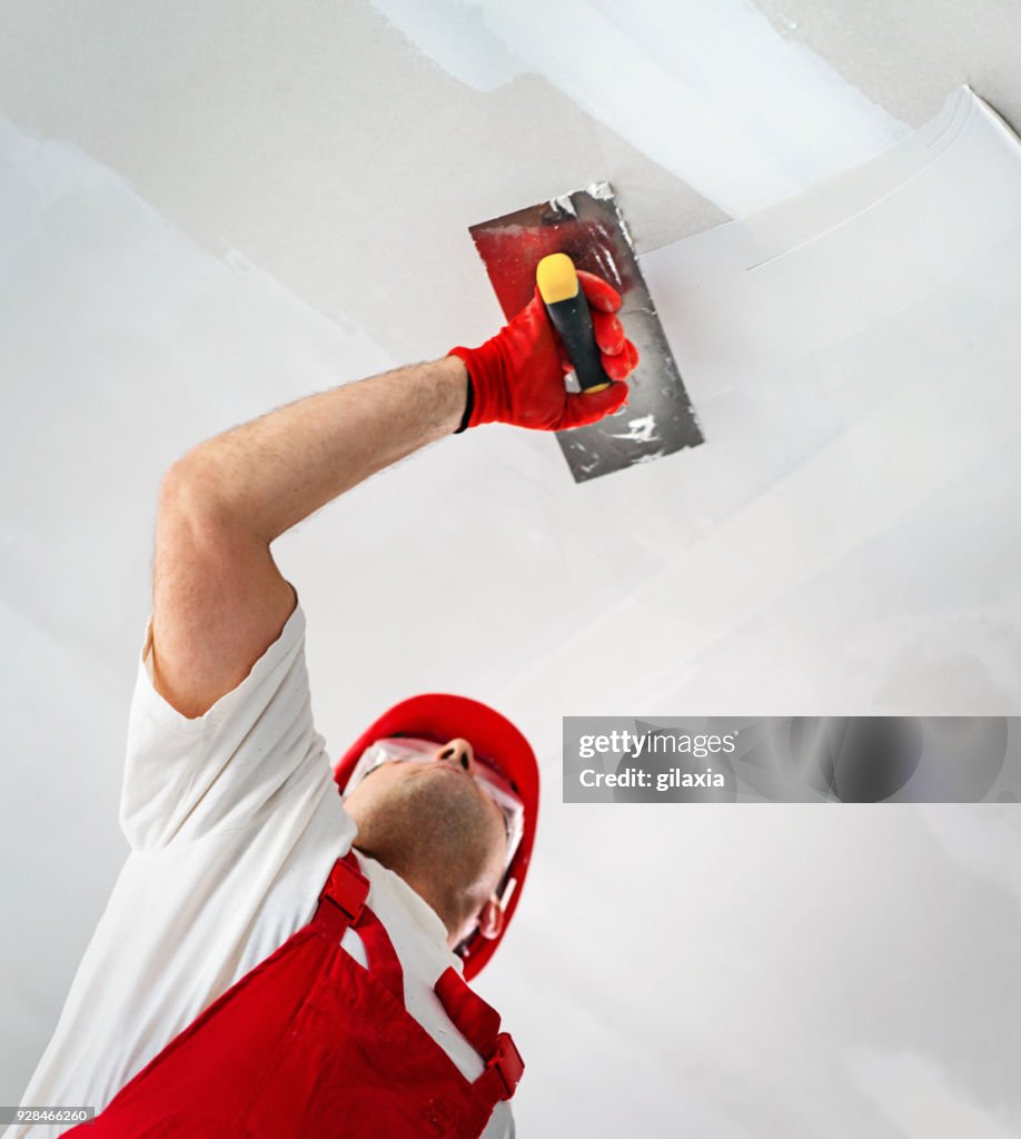 Construction worker during interior decoration.