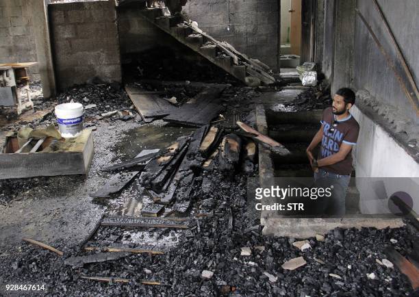 Man looks at a burnt home a day after anti-muslim riots erupted in Digana, a suburb of Kandy on March 7, 2018. Sri Lanka on March 5 declared a...