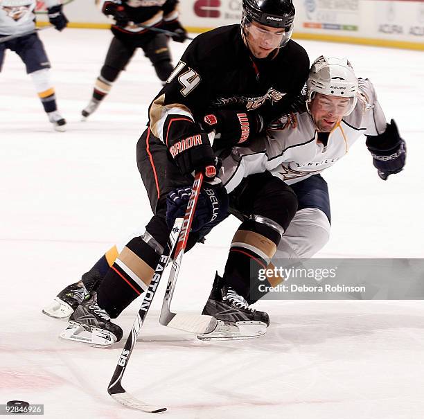 Dan Hamhuis of the Nashville Predators reaches for the puck against Joffrey Lupul of the Anaheim Ducks during the game on November 5, 2009 at Honda...