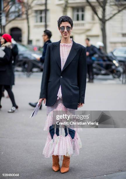 Yasmin Sewell wearing oink dress seen outside Miu Miu during Paris Fashion Week Womenswear Fall/Winter 2018/2019 on March 6, 2018 in Paris, France.