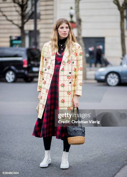 Veronika Heilbrunner wearing yellow plaid coat, red, black tartan dress is seen outside Miu Miu during Paris Fashion Week Womenswear Fall/Winter...