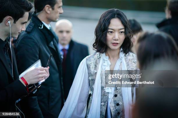 Bae Doona wears a shirt, outside Louis Vuitton, during Paris Fashion Week Womenswear Fall/Winter 2018/2019, on March 6, 2018 in Paris, France.