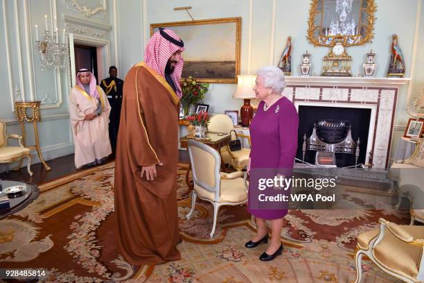 Queen Elizabeth II greets Mohammed bin Salman, the Crown Prince of Saudi Arabia, during a private audience at Buckingham Palace on March 7, 2018 in...