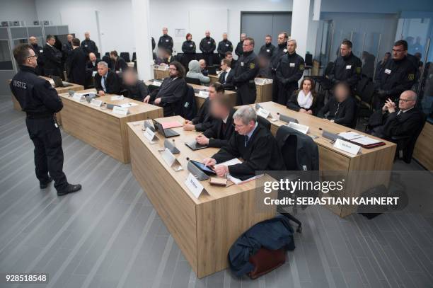 Defendants sit next to their lawyers at a courtroom in Dresden, eastern Germany, where members of the so-called "Freital group" faced trial on March...