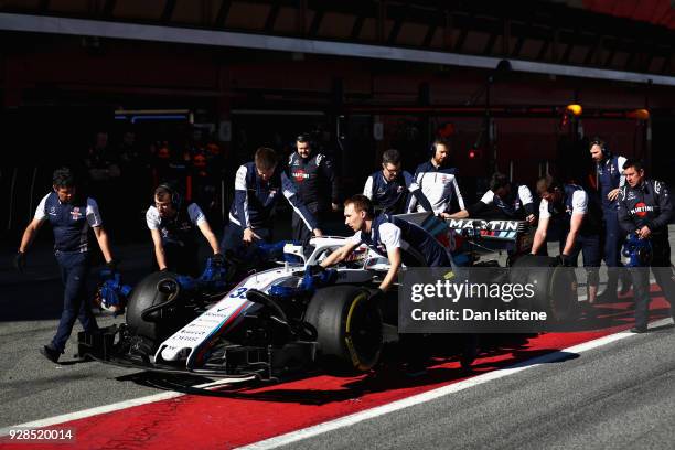 Sergey Sirotkin of Russia driving the Williams Martini Racing FW41 Mercedes is recovered from the pit lane during day two of F1 Winter Testing at...