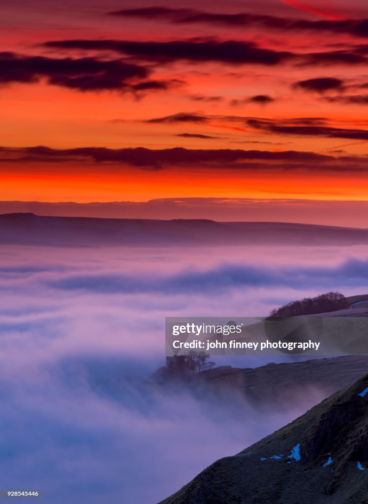 Red Dawn over Peveril Castle in the English Peak District. UK.