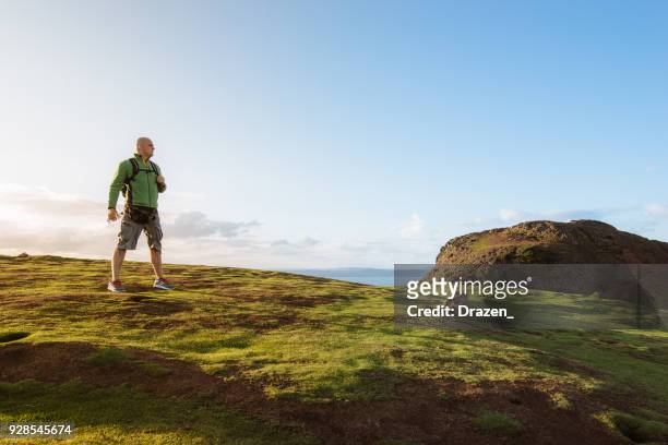 courageous hiker on the top of the hill - edinburgh scotland autumn stock pictures, royalty-free photos & images
