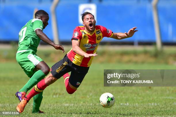 Kenya's Gor Mahia Ernest Wendo tackles Tunisia's Esperance Sportive de Tunis Bilel Mejri during their Confederation of African Football Champions...