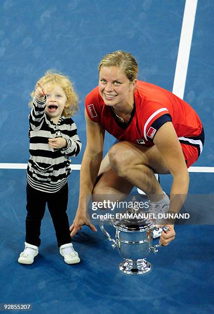 Tennis player Kim Clijsters from Belgium is joined by her daughter Jada after winnings against Caroline Wozniacki from Denmark during the Women's...