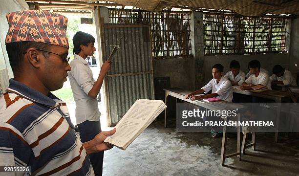 Bhutanese refugee takes a class of students at The Oasis Academy at The Timai Refugee Camp some 300kms south-east of Kathmandu on October 8, 2009....