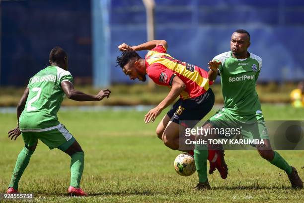 Kenya's Gor Mahia Jacques Tuyisenge tackles Tunisia's Esperance Sportive de Tunis Ivorian midfielder Fousseny Coulibaly during their Confederation of...