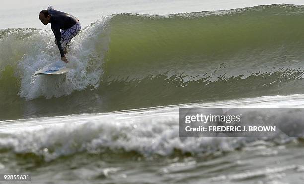 To go with AFP story by Dan Martin: LIFESTYLE-CHINA-LEISURE-SURFING A surfer rides a wave in the South China Sea at Houhai Beach outside of Sanya on...