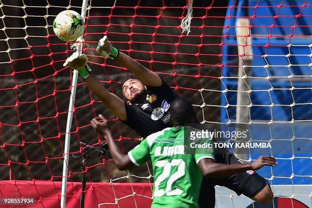 Tunisia's Esperance Sportive de Tunis goalkeeper, Moez Ben Cherifia deflects a shot by Kenya's Gor Mahia Meddy Kagere during their Confederation of...