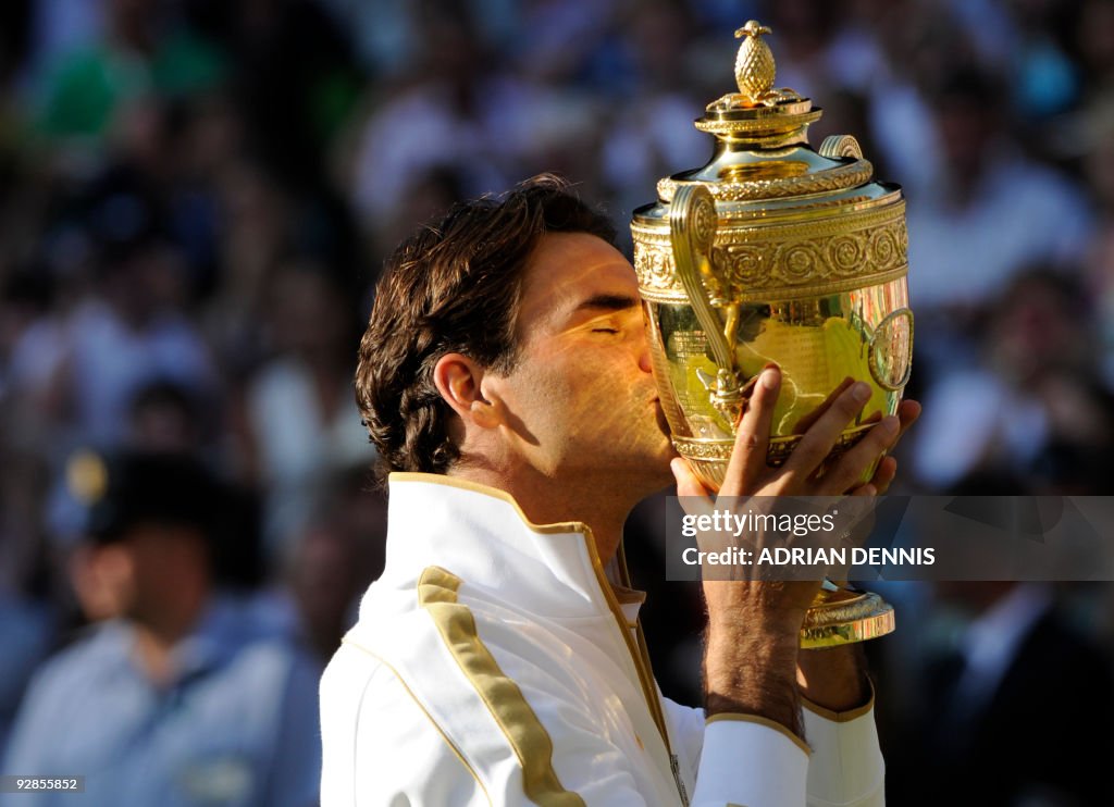 Switzerland's Roger Federer holds the tr