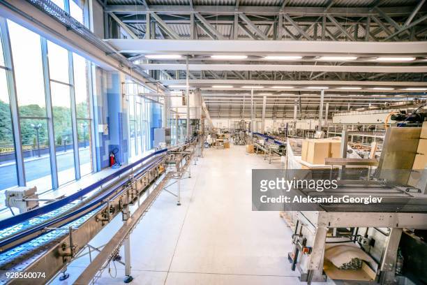 production line and machines in water bottling factory - fog machine stock pictures, royalty-free photos & images